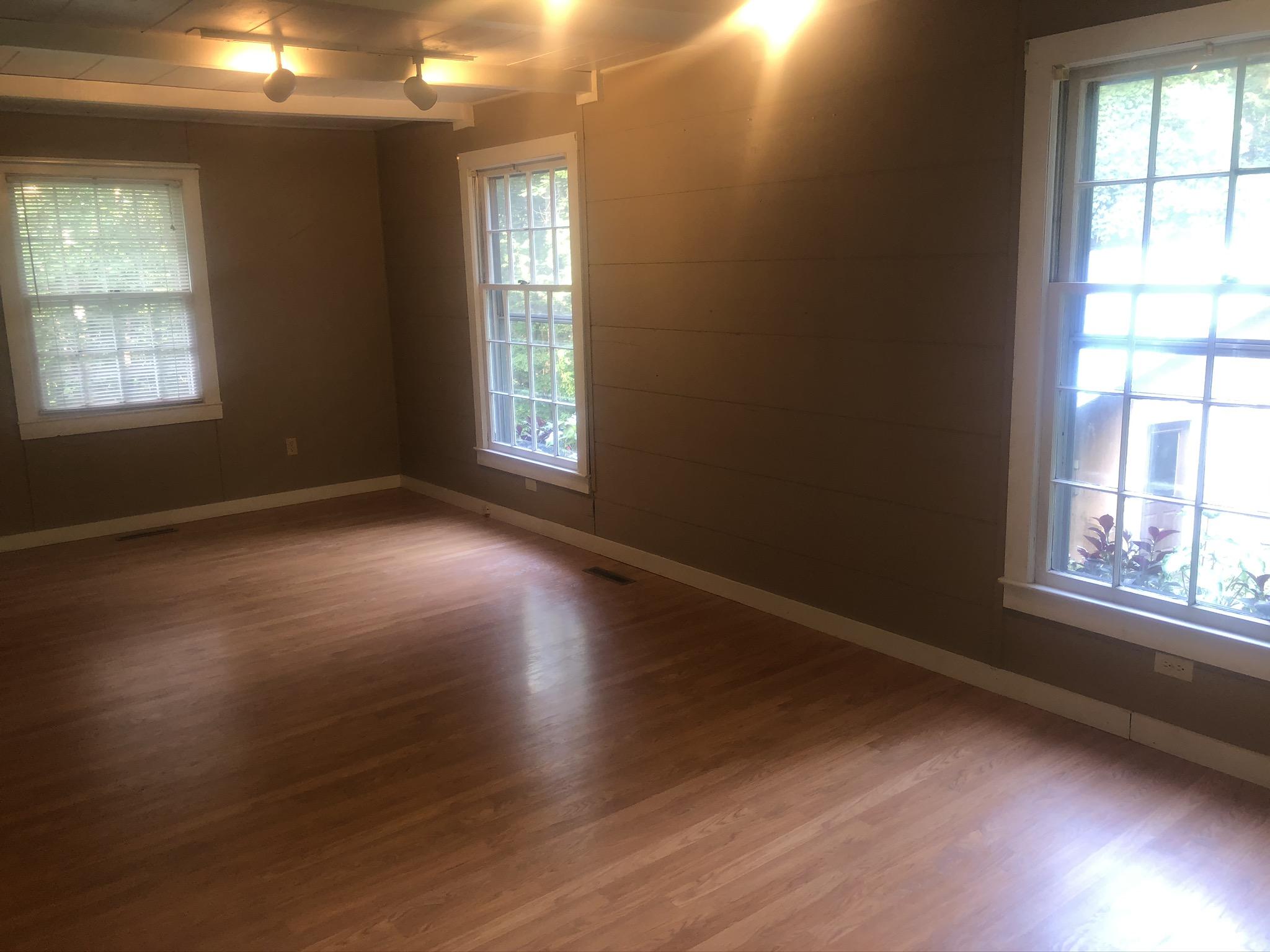 5453 Providence Church Road Ferrum, VA 24088 - Photo 5 of 16 an empty room with wooden floor and windows