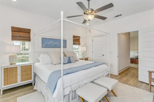 a bedroom with a bed and wooden floor