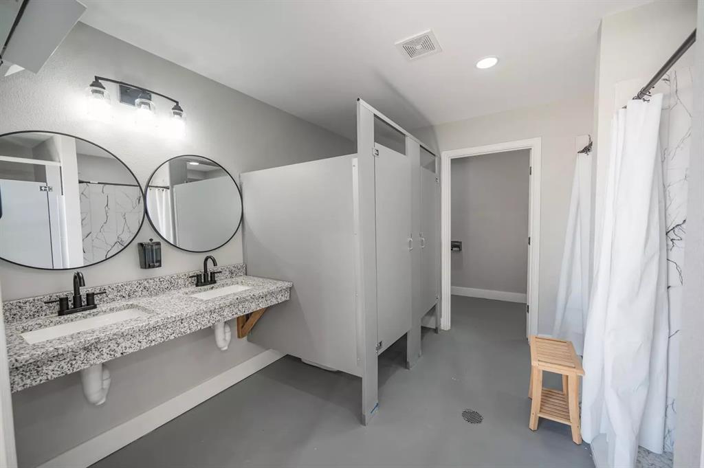 Lot 61 Rocco Dr Mount Mount Pleasant, TX 75455 - Photo 18 of 24 a en suite bathroom with a double vanity sink and a mirror
