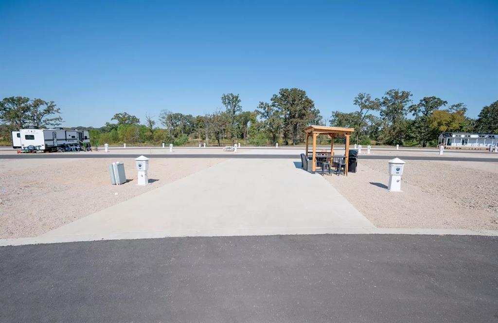 Lot 61 Rocco Dr Mount Mount Pleasant, TX 75455 - Photo 2 of 24 a swimming pool with outdoor seating and garden