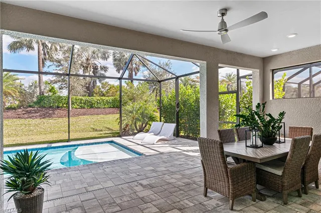 a living room filled with furniture and a potted plant