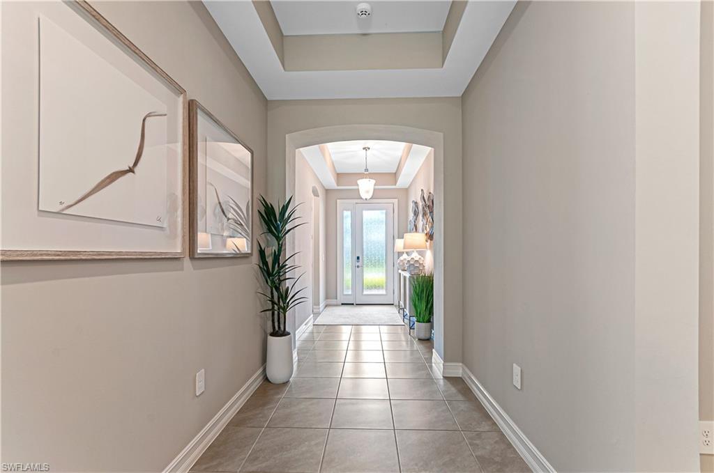 14506 Kelson Circle Naples, FL 34114 - Photo 3 of 25 a view of a hallway to a livingroom with furniture