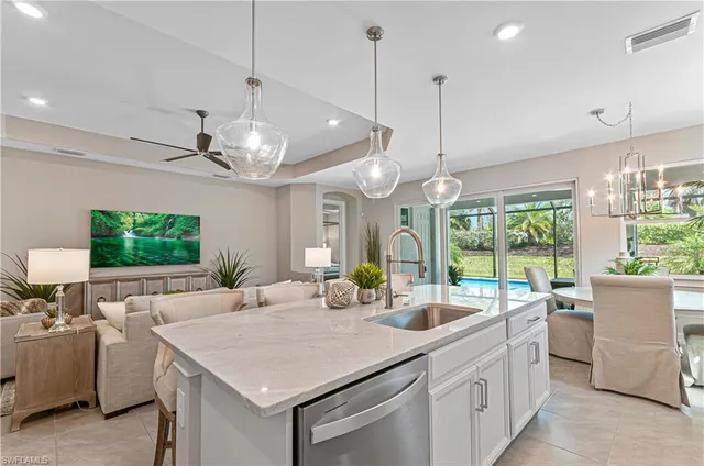 a living room with furniture ceiling fan and a large window