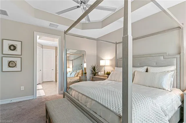 a bedroom with a large bed and a chandelier