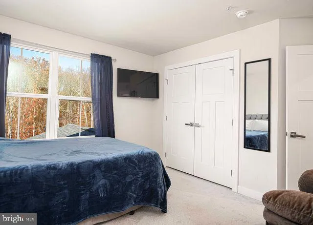 a bed sitting in a bedroom next to a window