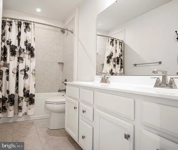 a bedroom with a bed a mirror and a large window