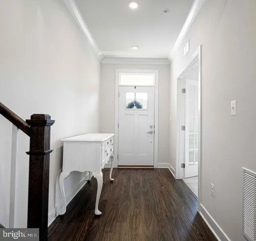 a view of hallway with wooden floor