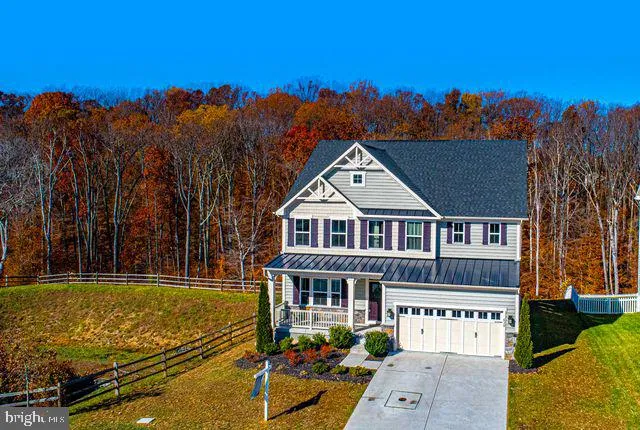 an aerial view of a house with a big yard