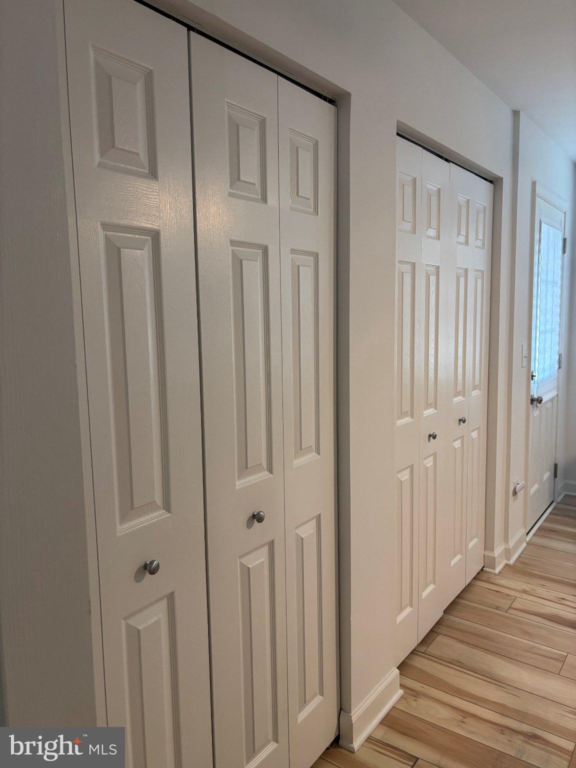 14800 Rydell Road, Unit 201 Centreville, VA 20121 - Photo 15 of 28 Sleek, modern hallway with storage doors.