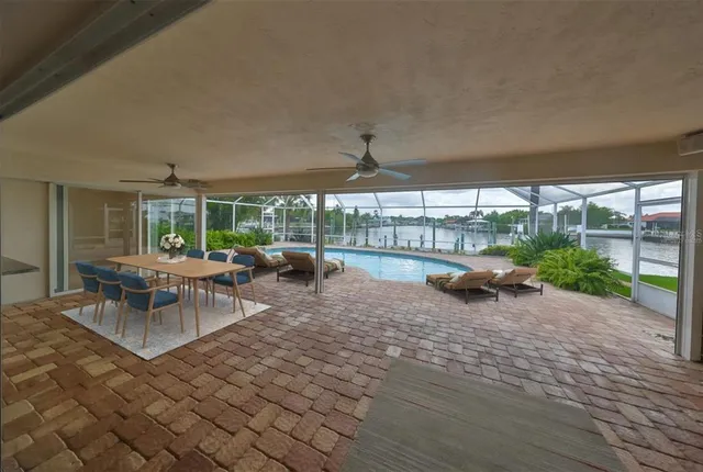 a view of a patio with a table and chairs under an umbrella