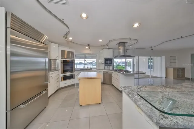a large kitchen with granite countertop lots of counter top space
