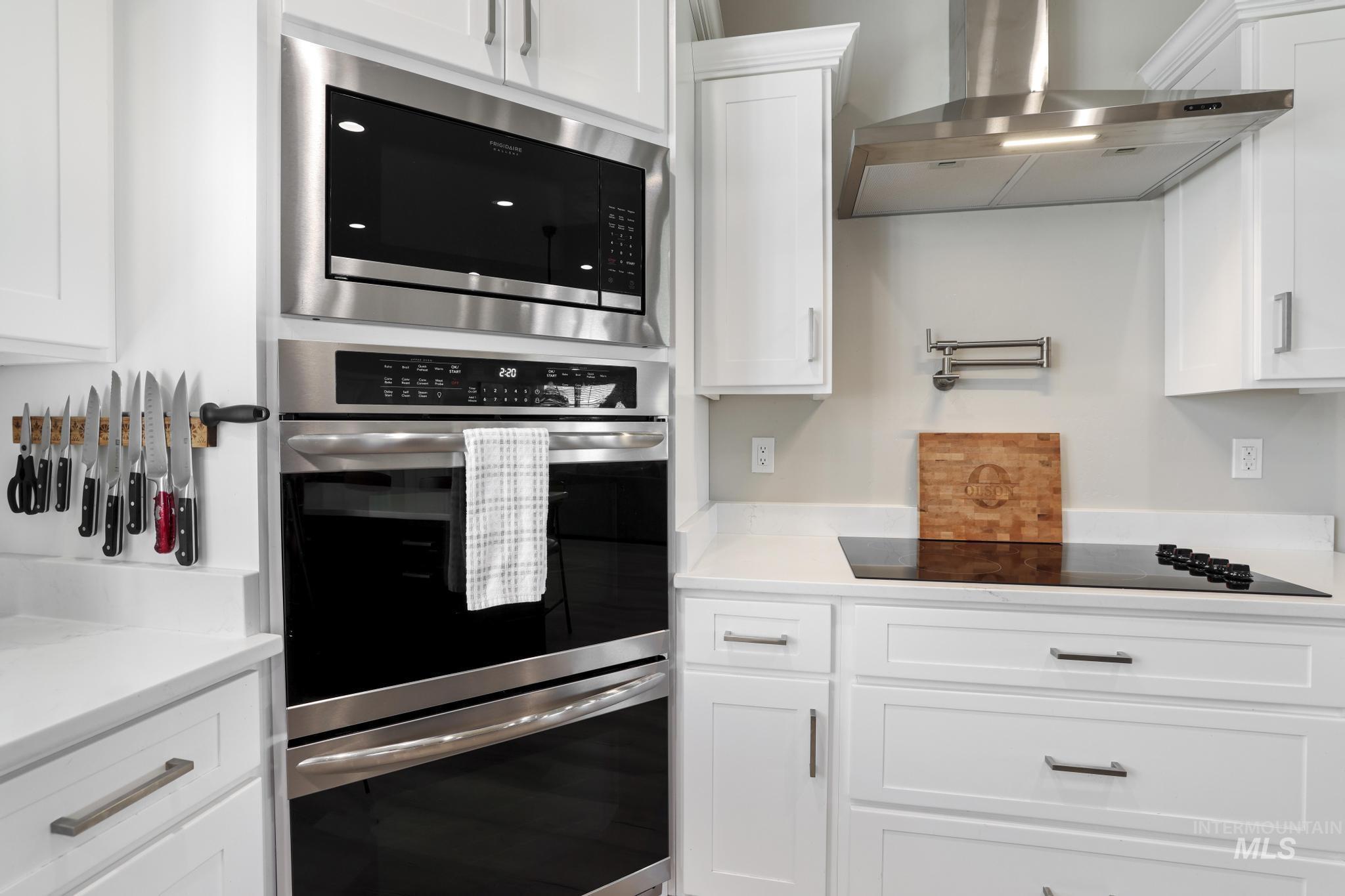 758 Cedar Crk Road Rogerson, ID 83302 - Photo 10 of 50 Modern kitchen featuring white shaker cabinetry, stainless steel appliances, a wall oven, a built-in microwave, and a black glass cooktop