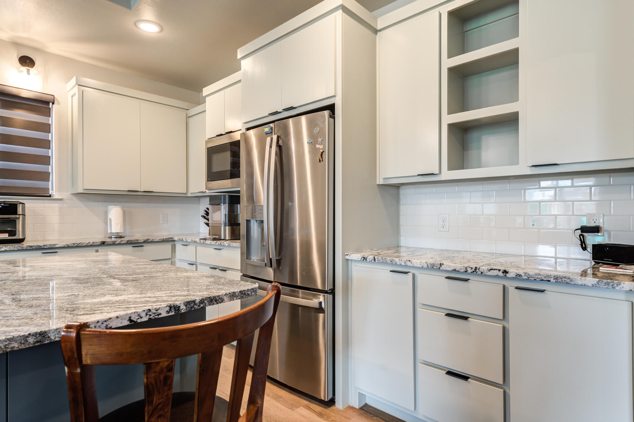 5722 118th Street Lubbock, TX 79424 - Photo 11 of 30 a kitchen with stainless steel appliances granite countertop a sink stove and refrigerator