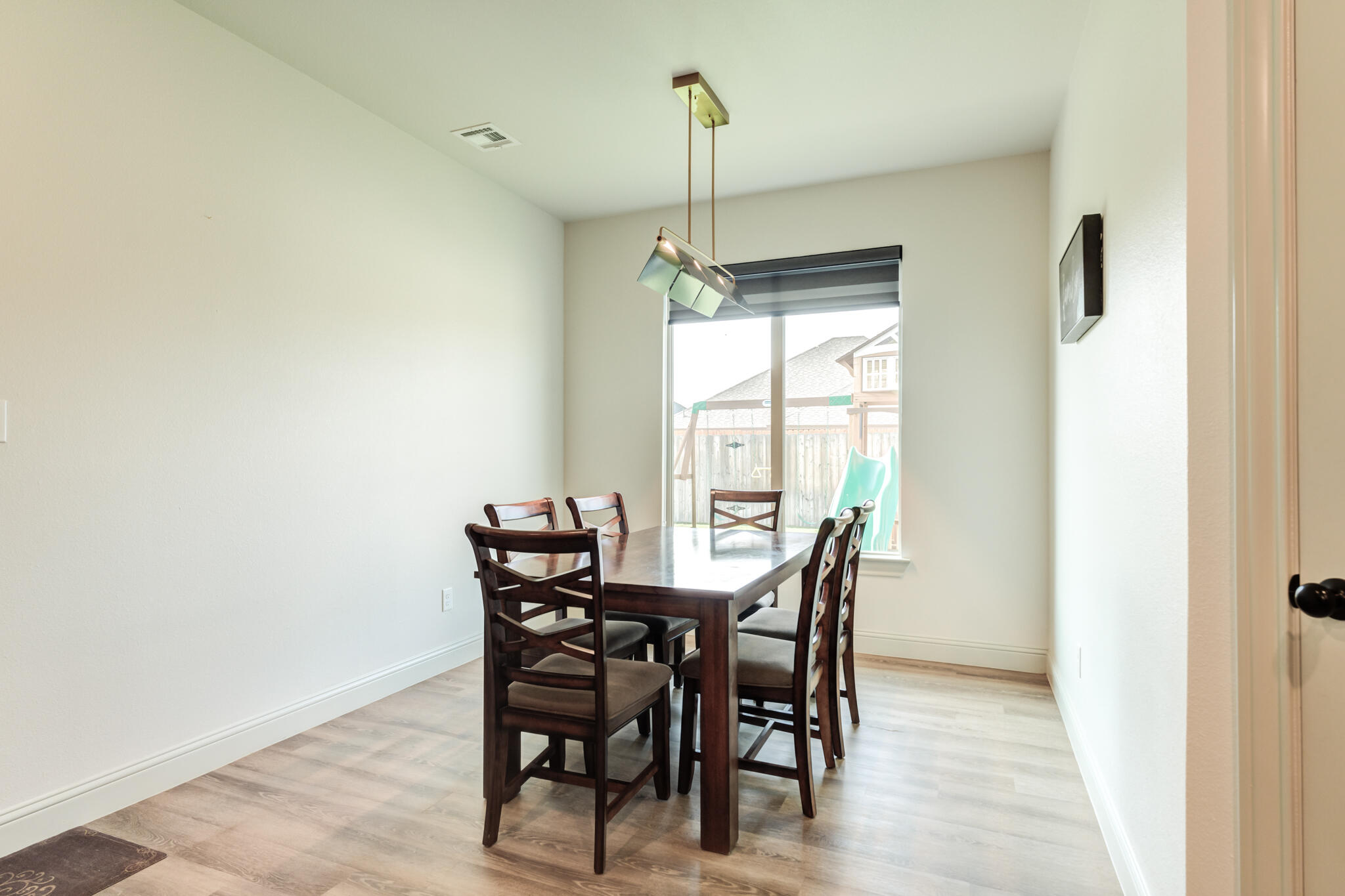 5722 118th Street Lubbock, TX 79424 - Photo 15 of 30 a view of a dining room with furniture window and wooden floor