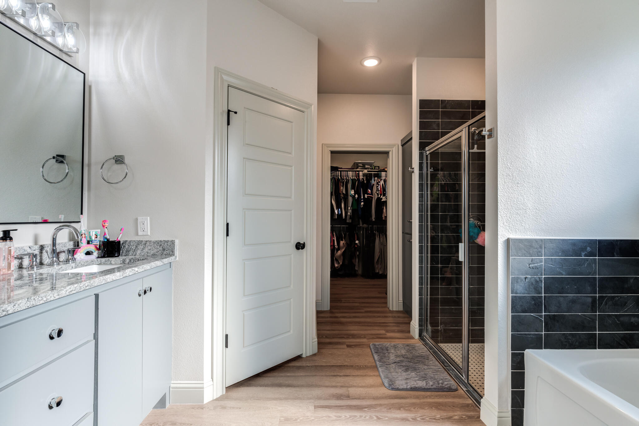 5722 118th Street Lubbock, TX 79424 - Photo 17 of 30 a bathroom with a tub shower vanity and a sink