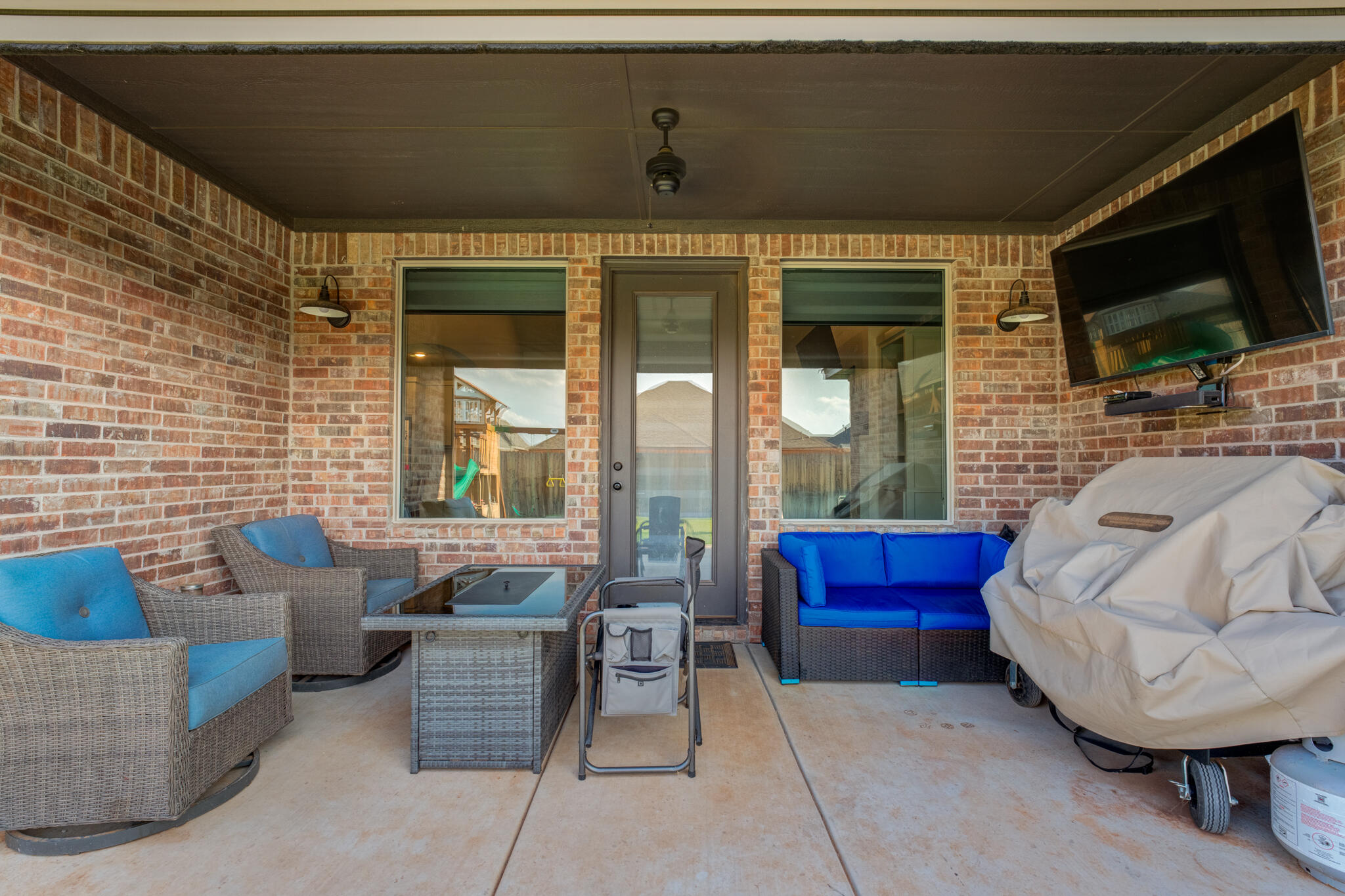 5722 118th Street Lubbock, TX 79424 - Photo 27 of 30 a living room with furniture a flat screen tv and a fireplace