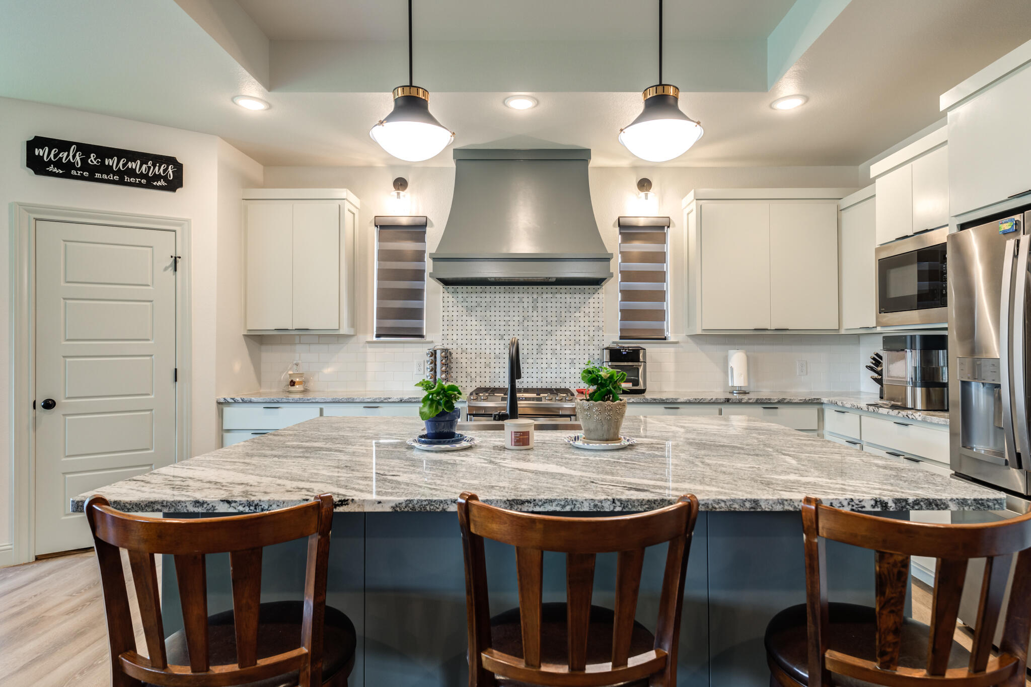 5722 118th Street Lubbock, TX 79424 - Photo 8 of 30 a kitchen with granite countertop a stove a sink a window and chairs