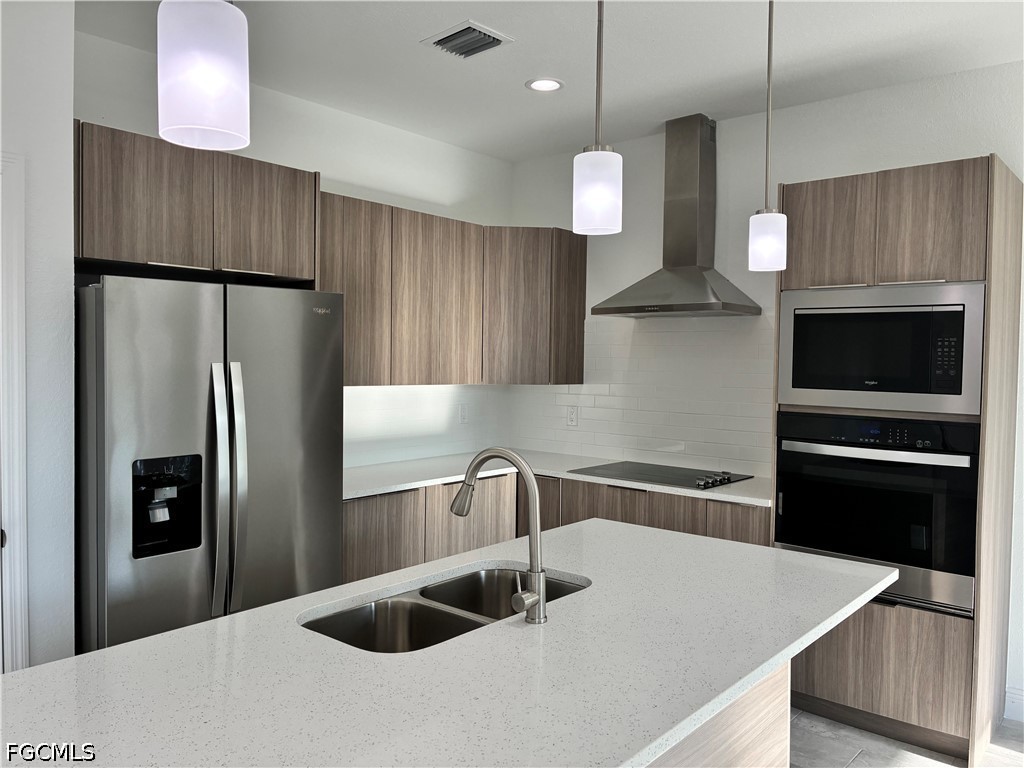 2022 Granada Road LaBelle, FL 33935 - Photo 11 of 43 a kitchen with stainless steel appliances a refrigerator and a sink