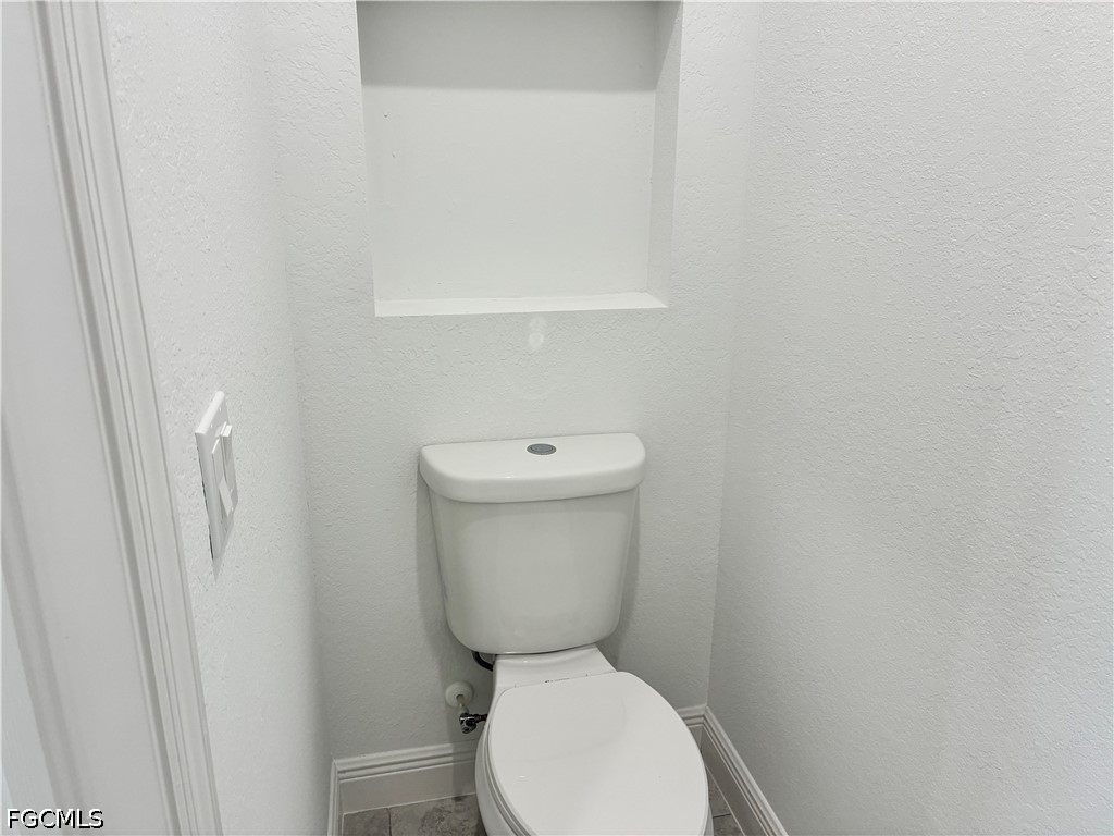 2022 Granada Road LaBelle, FL 33935 - Photo 22 of 43 a white toilet sitting next to a white cabinet