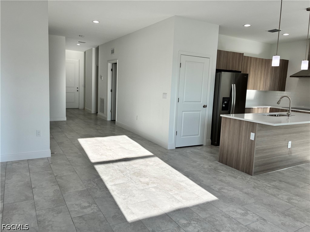 2022 Granada Road LaBelle, FL 33935 - Photo 26 of 43 a kitchen with a refrigerator and a sink