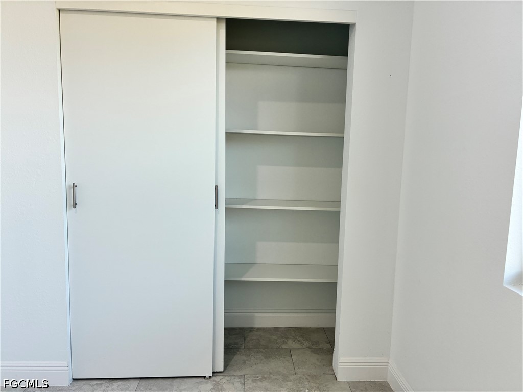 2022 Granada Road LaBelle, FL 33935 - Photo 31 of 43 a view of walk in closet with empty racks