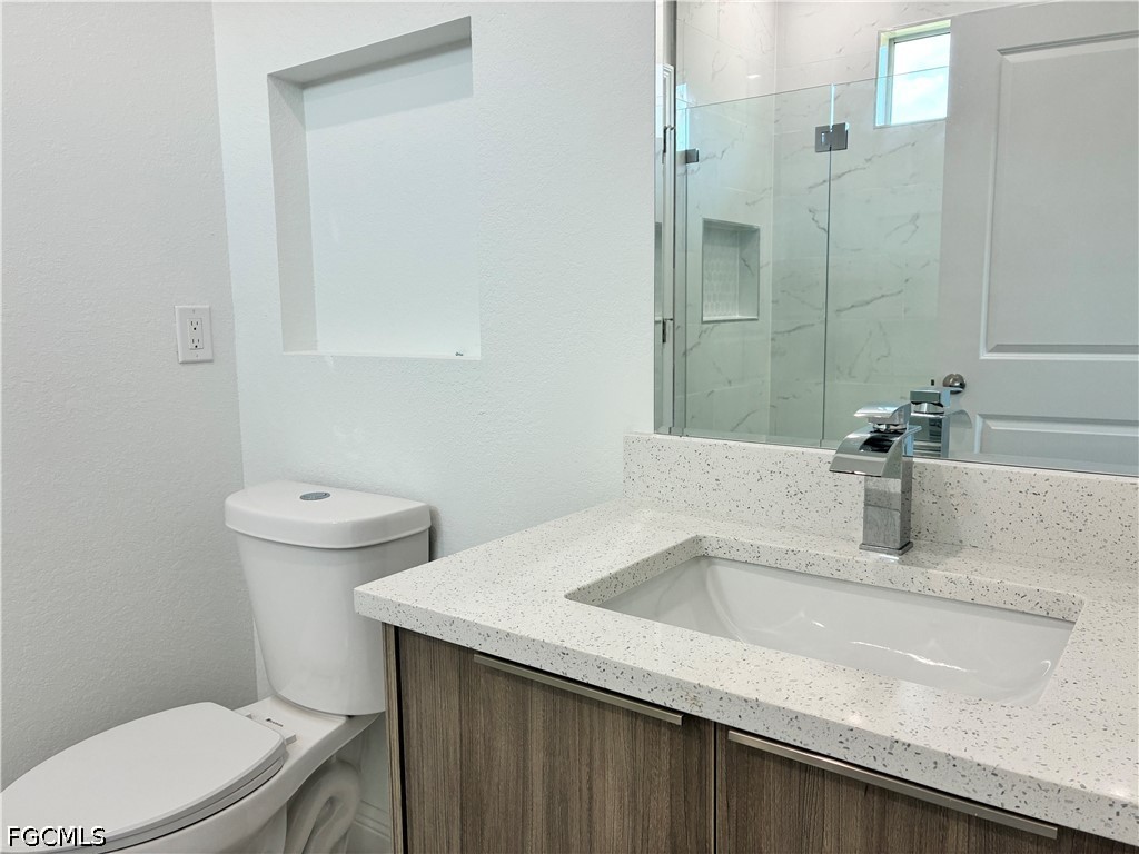 2022 Granada Road LaBelle, FL 33935 - Photo 32 of 43 a bathroom with a sink a toilet and shower