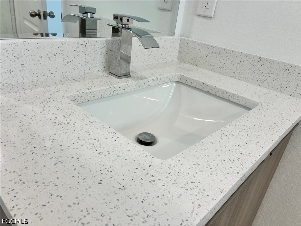 2022 Granada Road LaBelle, FL 33935 - Photo 34 of 43 a bathroom with a granite countertop sink