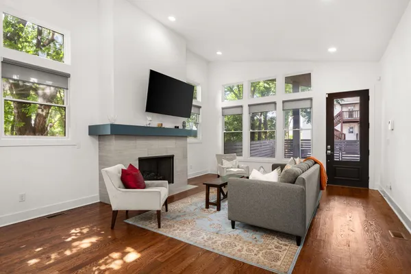 a living room with furniture a flat screen tv and a fireplace