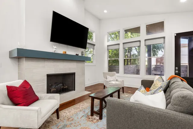 a living room with furniture fireplace and flat screen tv