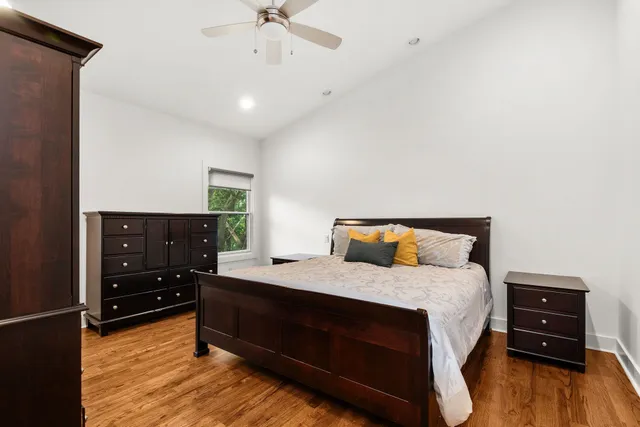 a bedroom with a bed and wooden floor