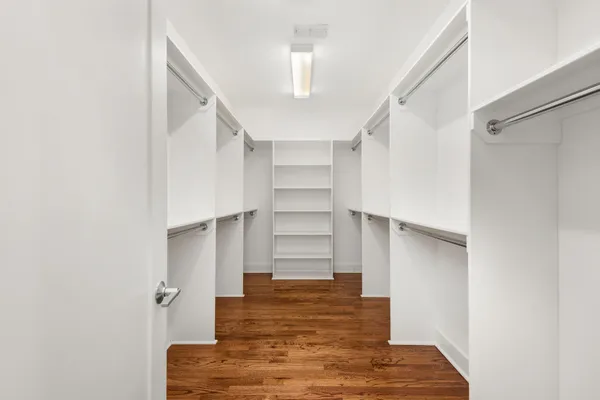 a view of walk in closet with empty racks