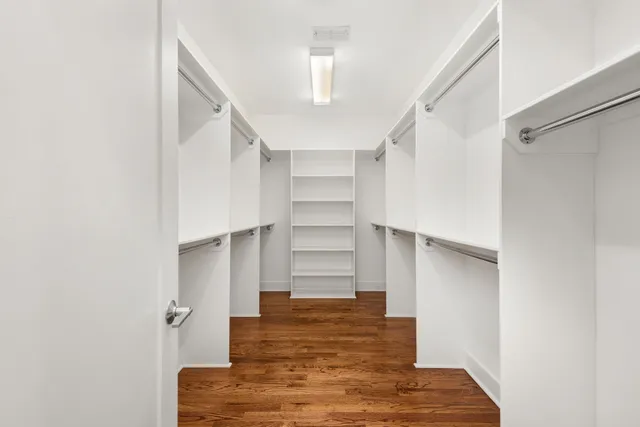 a view of walk in closet with empty racks