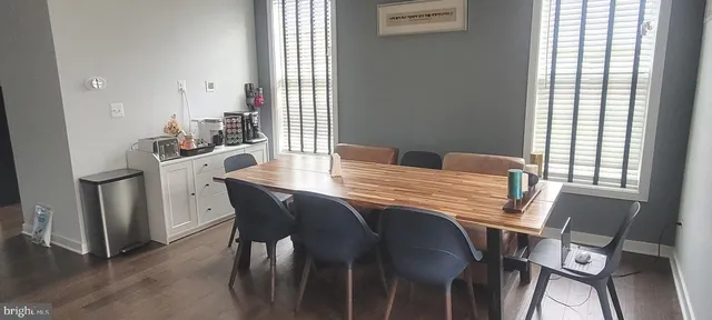 a kitchen with kitchen island a sink appliances and a large window