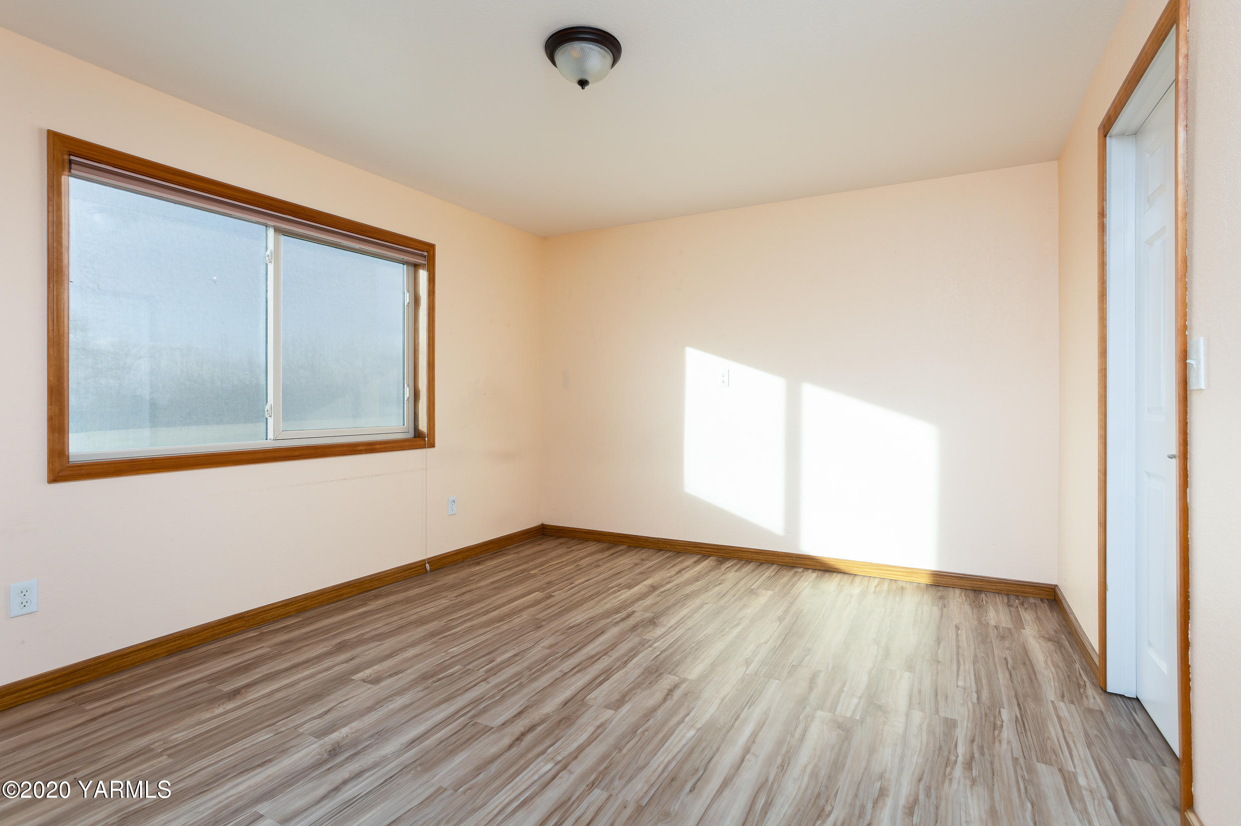 9800 Bittner Road Yakima, WA 98901 - Photo 30 of 45 a view of an empty room with wooden floor and a window