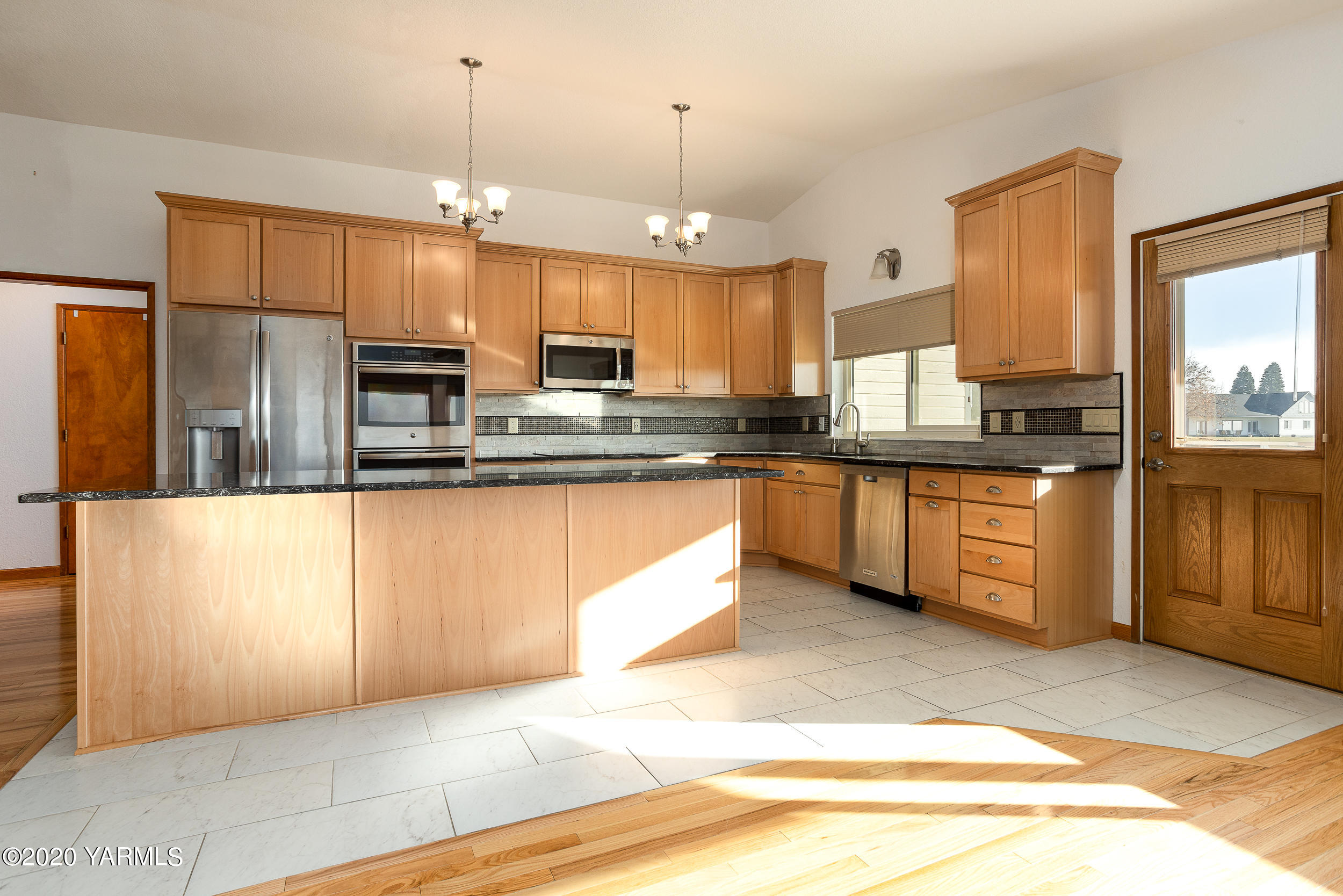 9800 Bittner Road Yakima, WA 98901 - Photo 7 of 45 a large kitchen with stainless steel appliances kitchen island granite countertop a stove a sink dishwasher and a refrigerator