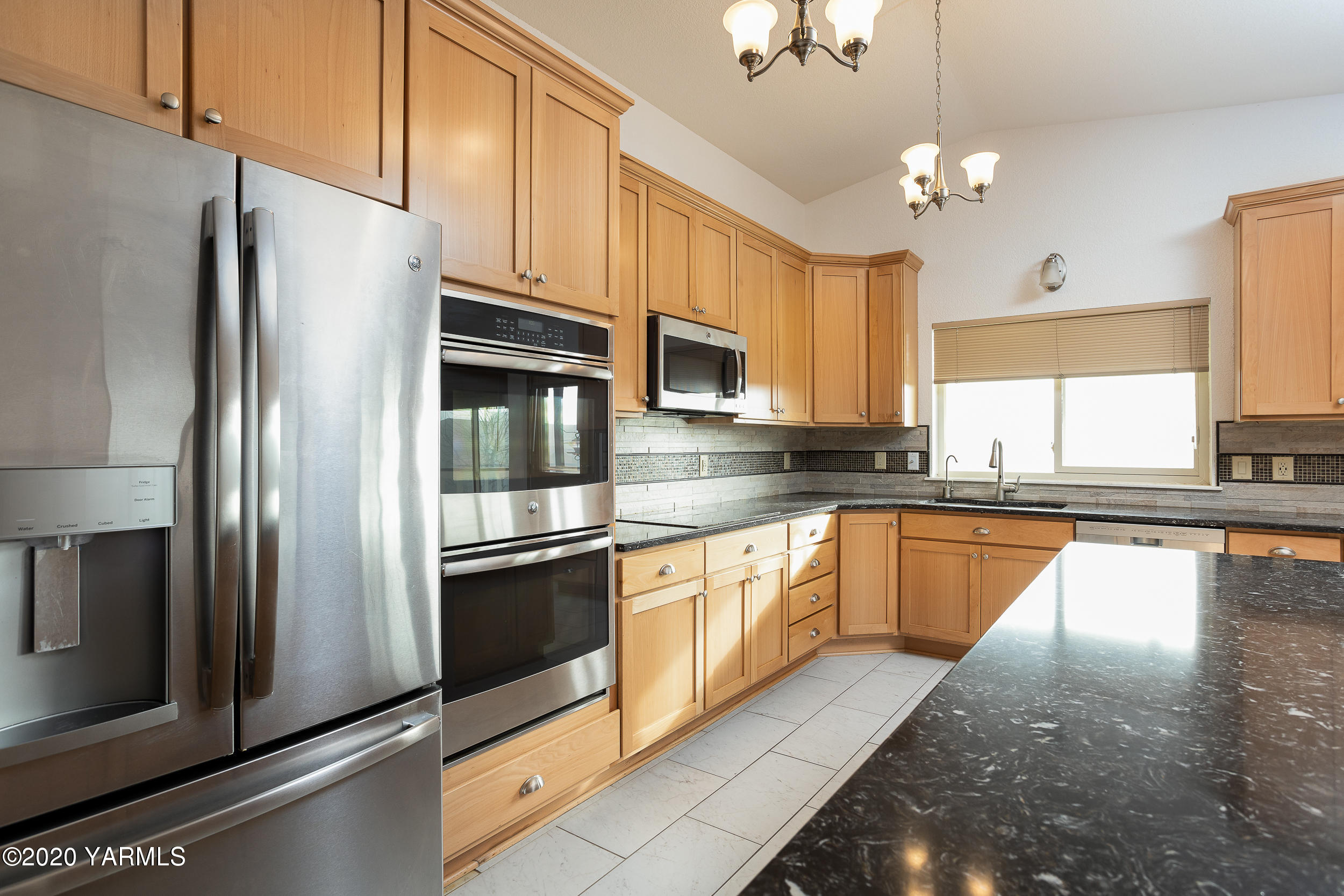 9800 Bittner Road Yakima, WA 98901 - Photo 10 of 45 a kitchen with stainless steel appliances granite countertop a refrigerator a stove a sink dishwasher a oven with large countertops and cabinets