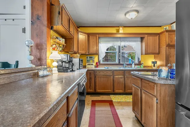 a kitchen with a sink stove and cabinets