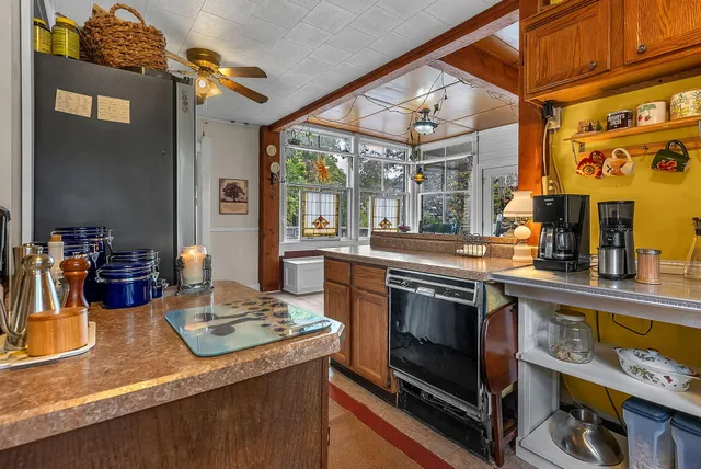 a living room with furniture a window and a fireplace