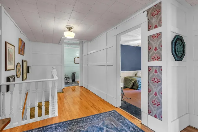 a bed sitting in a spacious bedroom next to a window
