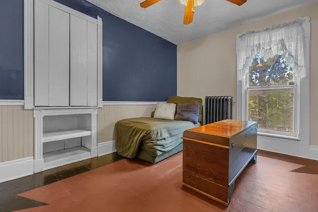 a bedroom with a bed and a tv