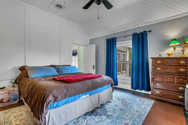 a view of a room with wooden floor