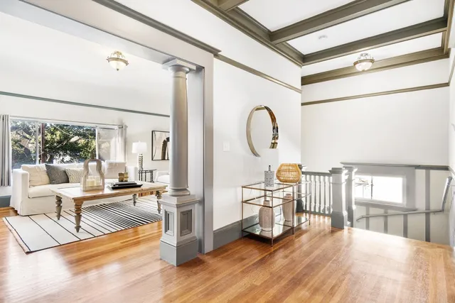 a living room with furniture a fireplace and wooden floor