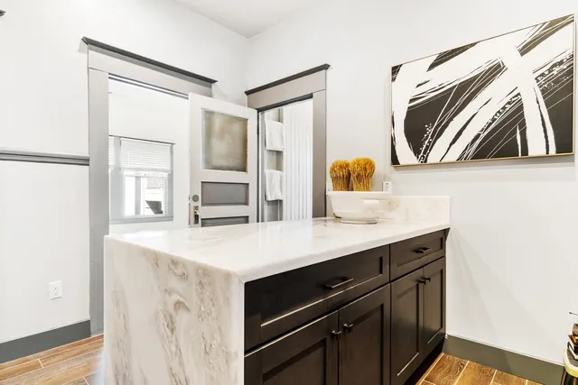 a kitchen with a sink cabinets and wooden floor