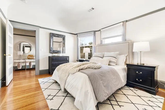 a view of a white house with a yard patio and a small yard