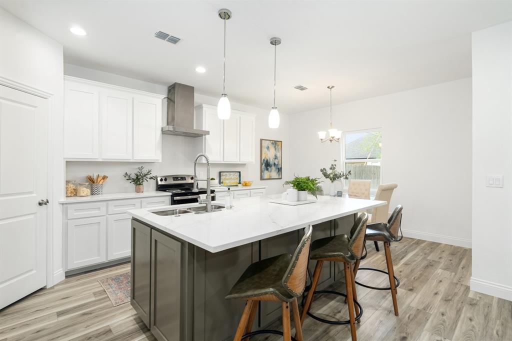 228 Windjammer Road Gun Barrel City, TX 75156 - Photo 7 of 19 a kitchen with kitchen island a stove a table a sink and cabinets
