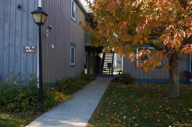 a view of a house with a small yard and a large window