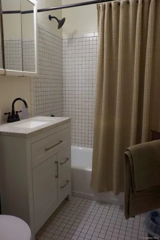 a bedroom with a bed and a cabinet