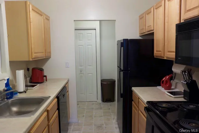 a kitchen with stainless steel appliances a stove a microwave and a refrigerator