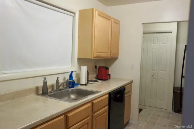 a kitchen with a sink and a stove top oven