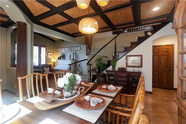 a view of a dining room with furniture and a chandelier